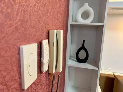 a wall with two light switches and a shelf at Executive Suite Air Residence Style Comfort Makati 300 Mbps in Manila