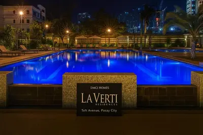 a large swimming pool with blue lighting at night at La Verti Residences Unit 1420 I Skyline Views & Luxe Stay Near MOA in Manila
