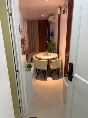 a small dining room with a table and chairs at Modern Studio near MOA, Airport & Heart of Pasay in Manila
