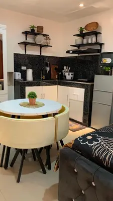 a kitchen with a table and a dining room at Modern Studio near MOA, Airport & Heart of Pasay in Manila
