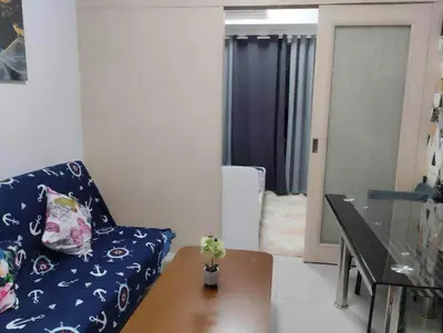 a living room with a couch and a table at Bini Comfort room in Manila