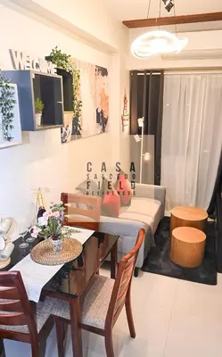 a living room with a couch and a table and chairs at CASA Salcedo - Field Residences in Manila