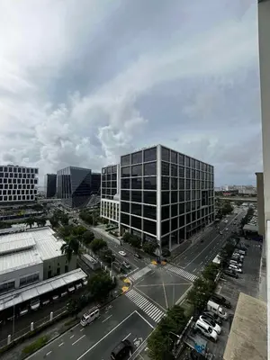 an aerial view of a city with a large building at Affordable Condo staycation near MOA ,NAIA & Airport 4 GUESTS WIFI,NETFLIX,POOL in Manila