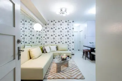 a living room with a couch and a table at NEW 2BR Family Home with FREE Parking & Fiber Wi-Fi in Manila