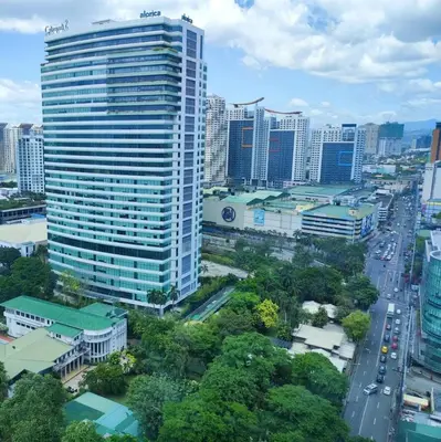 a city skyline with a tall building and a road at Kael Studio in Manila