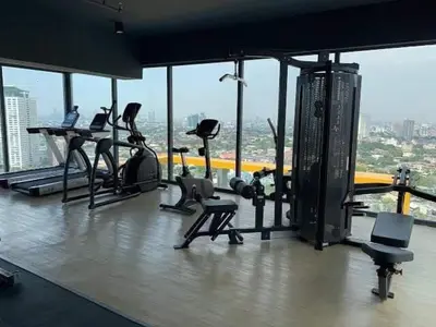 a gym with treadmills and exercise equipment in a building at Modern Tropical Home In The Heart of Quezon City in Manila