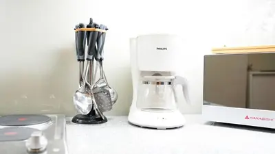 a blender sitting on a counter next to a microwave at Best 1BR in Uptown BGC - Near Mitsukoshi & Malls in Manila