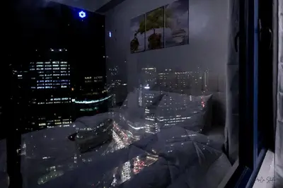 a room with a view of a city at night at Condo in Makati Staycation in Manila