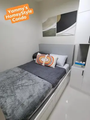 a small bedroom with a bed in a room at Yammy's HomeyStyle Condo at Tower 3 Shore 3 Residences in Manila