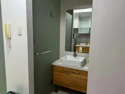 a bathroom with a sink and a mirror at Eve's Den in Manila