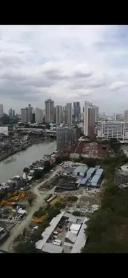 an aerial view of a city with a river and buildings at Eve's Den in Manila