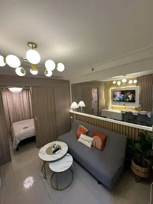 a living room with a couch and a table at Staycation At Shore 2 Residences Tower 2 in Manila