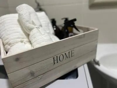 a wooden box with white towels in a bathroom at Luxury in the Makati Skyline in Manila