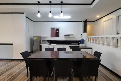 a kitchen and dining room with a table and chairs at Jewelry Resort and Villas Tagaytay in Silang