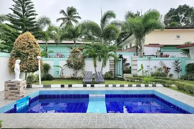 a swimming pool in the backyard of a house at Jewelry Resort and Villas Tagaytay in Silang