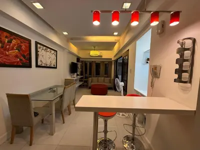 a waiting room with a table and some chairs at Luxury Condo at Forbeswood Parklane The Fort BGC in Manila