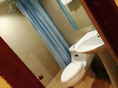 a bathroom with a white toilet and a sink at Chinatown Lai Lai Hotel Inc in Manila