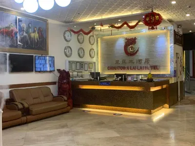 a lobby with a bar with a couch and clocks at Chinatown Lai Lai Hotel Inc in Manila