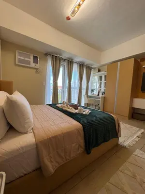 a bedroom with a large bed in a room at Venice Staycation Cozy Glimpse of Grand Canal View Retreat in Manila