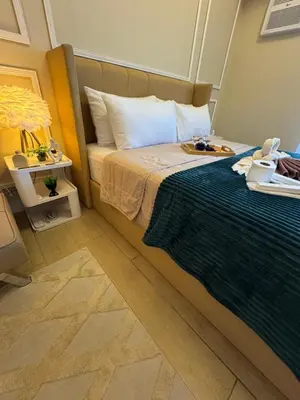 a bedroom with a bed with a blue blanket at Venice Staycation Cozy Glimpse of Grand Canal View Retreat in Manila
