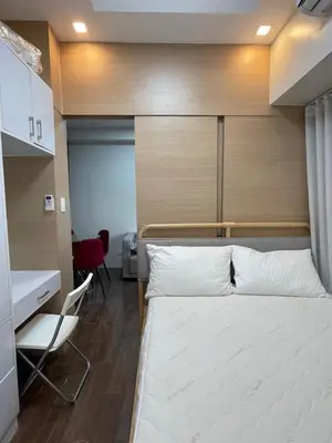 a bedroom with a bed and a desk and a chair at Beauty Makati Penthouse 4 room Family Condo in Manila