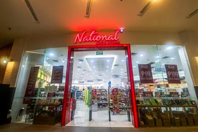 a national store with a red sign in the window at Beauty Makati Penthouse 4 room Family Condo in Manila