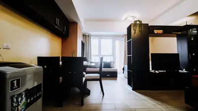 a room with a living room with a table and chairs at Venice Stay! Free Amenities, Steps to Grand Canal in Manila