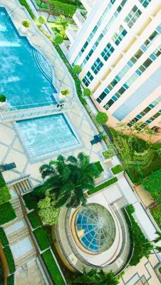 an overhead view of a resort with a pool and a building at Venice Stay! Free Amenities, Steps to Grand Canal in Manila