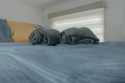 a bed with towels on top of it at Family Friendly Stay UrbanDeca in Manila