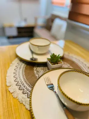 a table with three plates and a fork on it at Fablo Staycation By Enchanted Kingdom in Santa Rosa