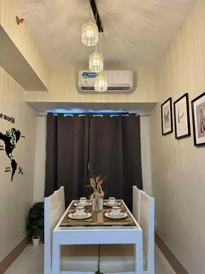 a white table and chairs in a room at Cassa Bella in Manila