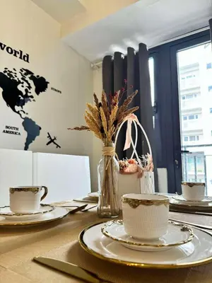 a table with plates and cups and a world map on the wall at Cassa Bella in Manila