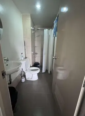 a small bathroom with a toilet and a sink at Tulip Garden Apricot Southwoods Binan 1BR with Pool & gym in Biñan