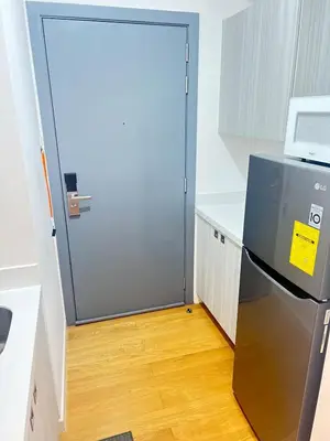 a door leading into a kitchen with a refrigerator at Acqua Private Residences -IGUAZU Tower 16th flr - Mandaluyong in Manila