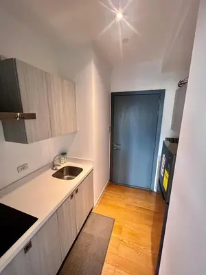 an empty kitchen with a sink and a door at Acqua Private Residences -IGUAZU Tower 16th flr - Mandaluyong in Manila