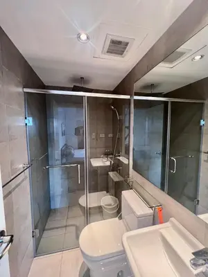 a bathroom with a shower and a toilet and a sink at Acqua Private Residences -IGUAZU Tower 16th flr - Mandaluyong in Manila