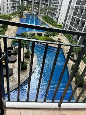 a view of a swimming pool from a balcony at Sweet Staycation in Manila