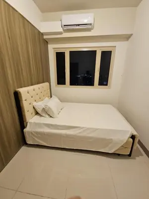 a small bedroom with a bed and a window at Condo next door in Manila