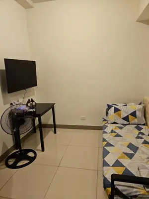 a room with a desk with a computer and a couch at Condo next door in Manila