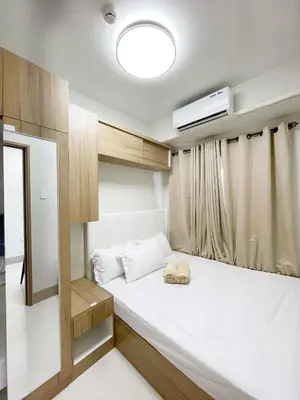 a small room with a bed with a projector at 212 Budget Condo at Shore 3 The Dwelling place in Manila