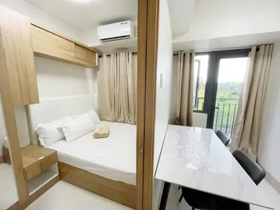a small room with a bed and a table at 212 Budget Condo at Shore 3 The Dwelling place in Manila