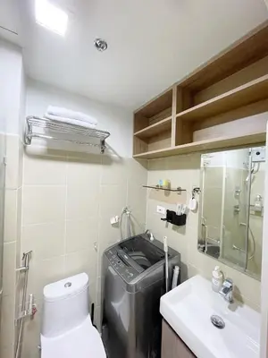 a bathroom with a washing machine and a sink at 212 Budget Condo at Shore 3 The Dwelling place in Manila