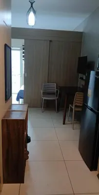 a living room with a table and a refrigerator at Staycation at a Breeze 01 in Manila