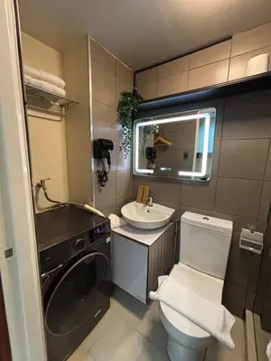 a small bathroom with a toilet and a sink at The Crystal Cove Cabin in Puting Kahoy