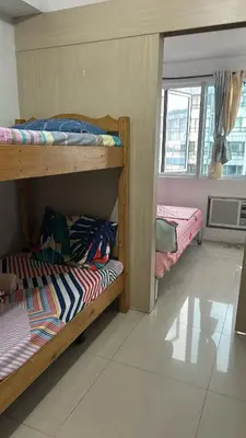 two bunk beds in a room with a window at Chay place sea residence in Manila
