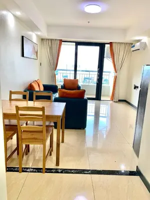 a living room with a table and a blue couch at Hotel S in Manila
