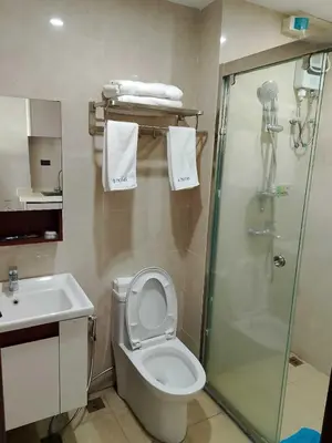 a bathroom with a shower and a toilet and a sink at Hotel S in Manila