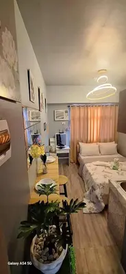 a living room with a bed and a table at G and A CONDOTELS in Manila