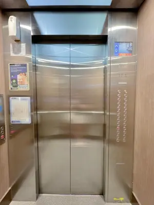 an elevator in a building with a metal door at Studio Suite at Fairway Terraces near NAIA T3 in Manila