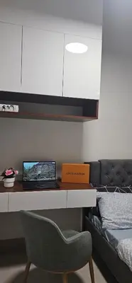 a bedroom with a desk with a laptop and a chair at 2 Bedroom Mall of Asia and Airport in Manila